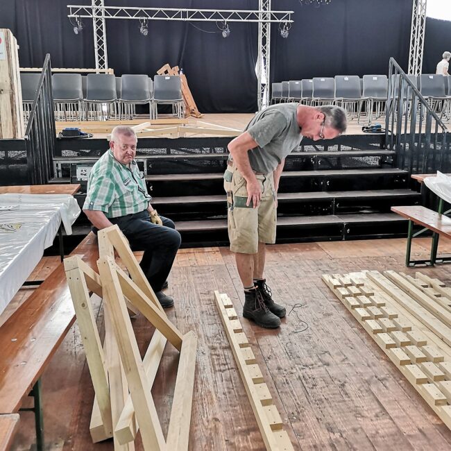 Im Festzelt werden die Fahnenhalter für die 100 Vereinsfahnen an der Veteranenehrung gebaut.